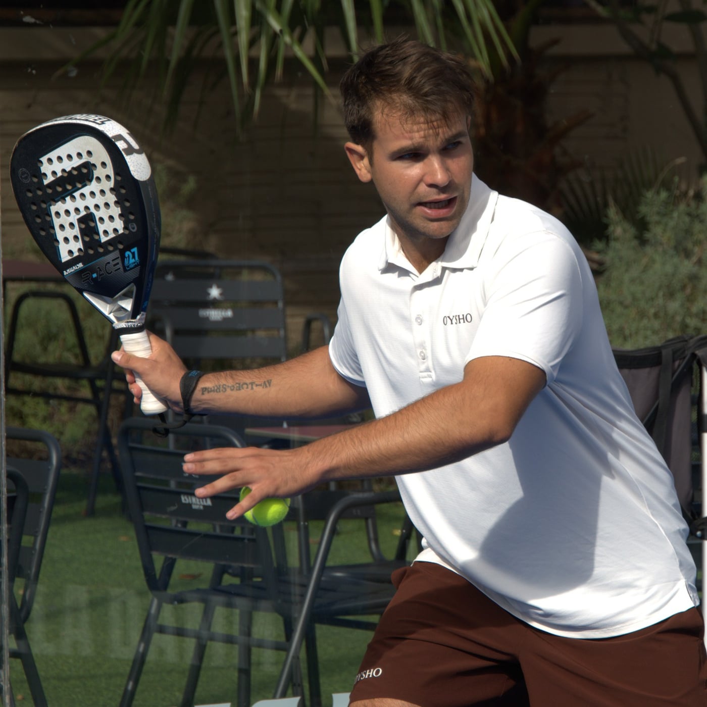 Max, head coach at Barcelona Padel Escapes, close up in a white polo shirt